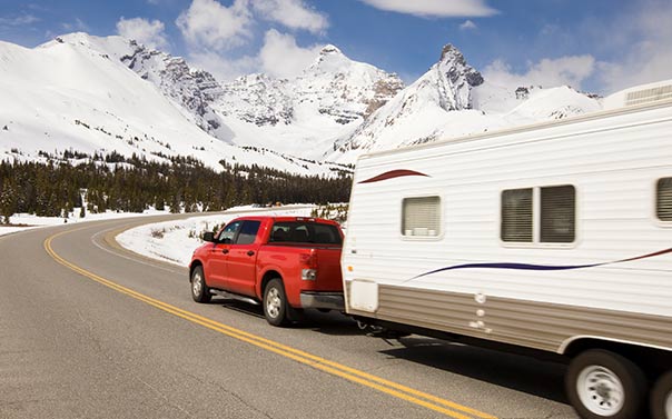 A red Toyota Tundra pulling a trailer